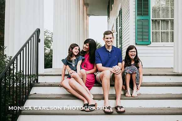 family of four laughing together on the patio at Barrington Hall