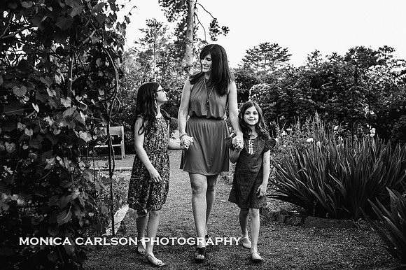mother walking through a garden with her daughter
