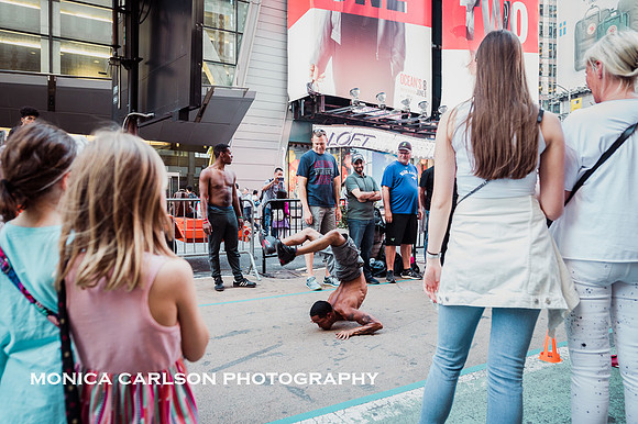 People watching street performers in Times Square by monica carlson