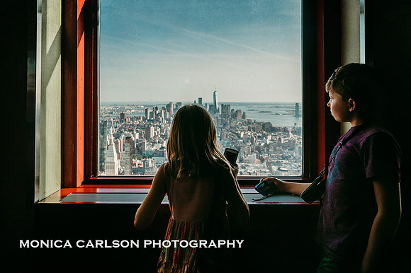 brother and sister admiring the view from empire states building