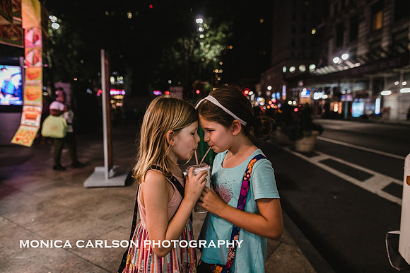 girls sharing a milk shake on the streets of New york city