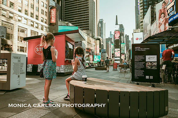 Girls drinking starbucks while looking around times square