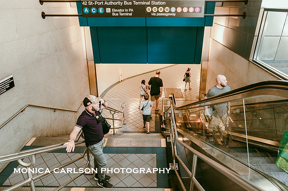 family descends the stairs to the subway at the port authority station