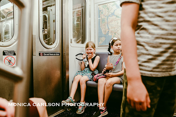 girl and her sister excitedly taking their first ride on NYC subway