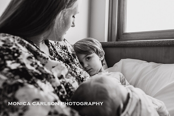 uncertain toddler shares his mother for the first time in a hospital room by monica carlson