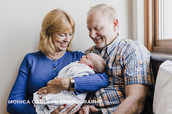 proud grandparents meet their new grandson in his hospital room