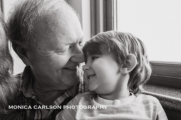 toddler boy and grandfather snuggle together and obviously have a sweet bond by monica carlson photography