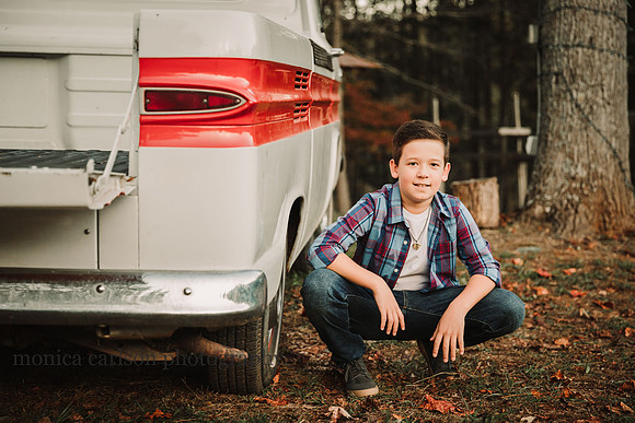 tween boy squats by a vintage truck by monica carlson