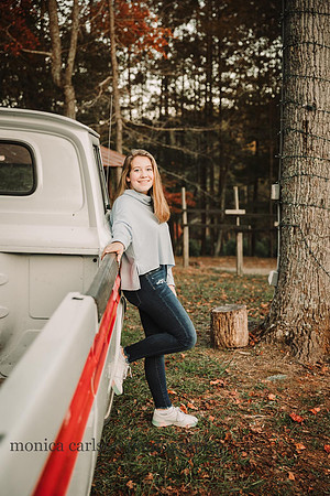 teen girl leans against a old truck during a mini session