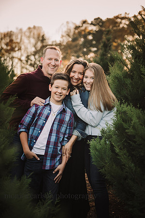 Family of four snuggle at hunters family farm