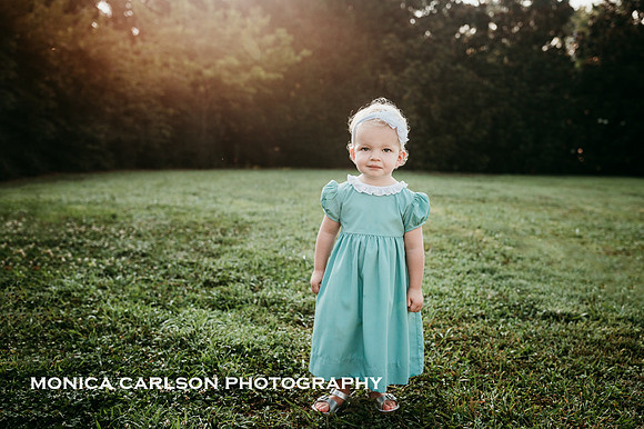 little girl stand in a green space at Barrington hall by monica carlson photography
