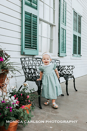 little girl standing on the porch of Barrington hall in Roswell, ga