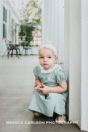 young girl squatting on the porch at Barrington hall