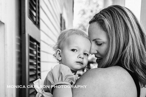 mother snuggling her baby during a family photo session with Monica Carlson
