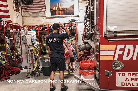 New York city fireman talks to a group of kids about being a fireman