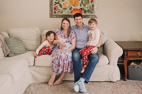 Family of takes a portrait in their home with monica carlson