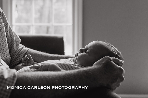 Portrait of a baby in his fathers arms by monica carlson photography