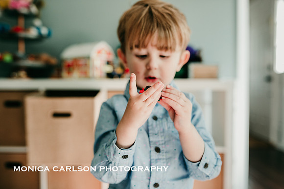 Young boy looking at a small toy in his home in Marietta