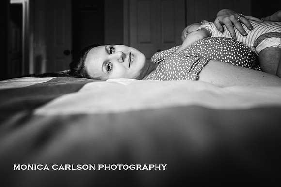 Lovely new mother laying on her bed with her baby at home outside Atlanta