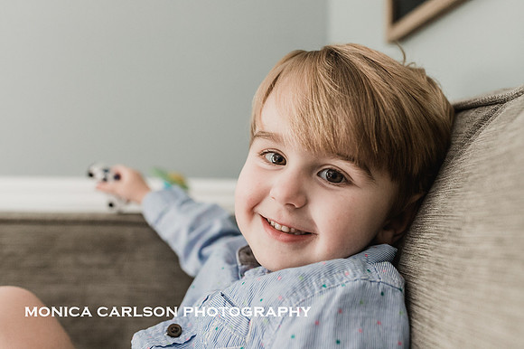Portrait of a smiling young boy sitting on a couch