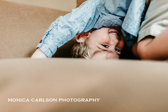 Little boy being silly on a couch