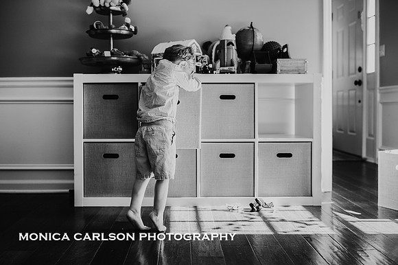 Portrait of a little boy playing in his home play room by Monica carlson photography