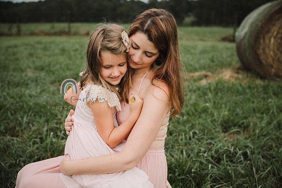 mother and daughter snuggle during a family photo session