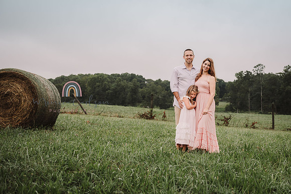 family of three standing on a field at Prospect farms