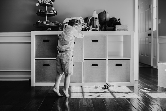 little boy searching for a toy in a his playroom in marietta, GA