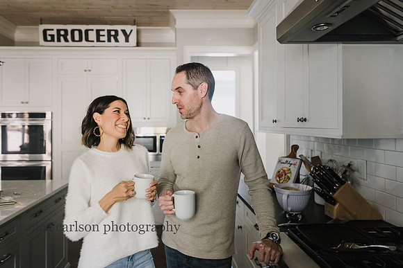 husband and wife drinking coffee in their kitchen during a family photo session