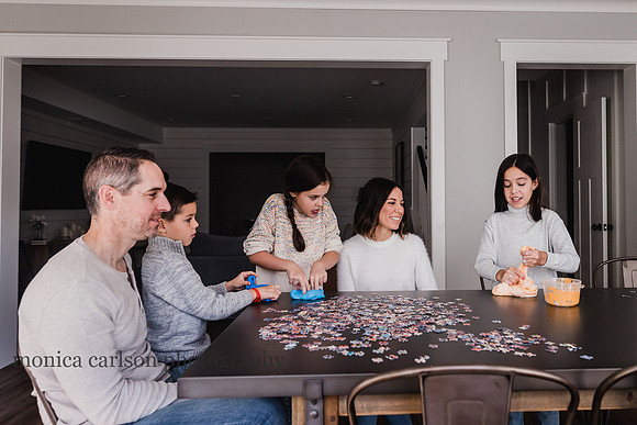 family bonding over slime and puzzles during a photo session with monica carlson