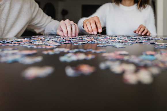 father and daughter making puzzles
