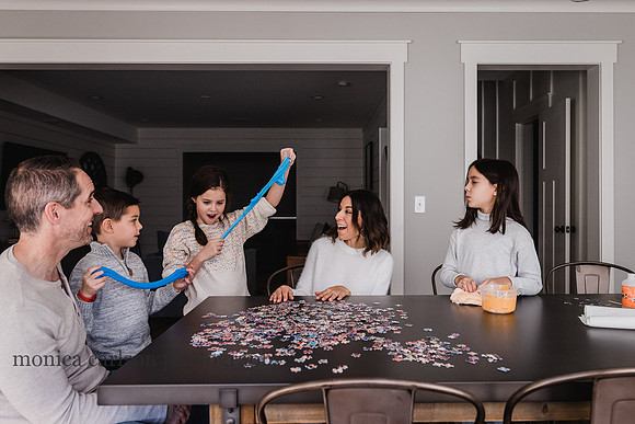 family watching a young girl stretch her slime
