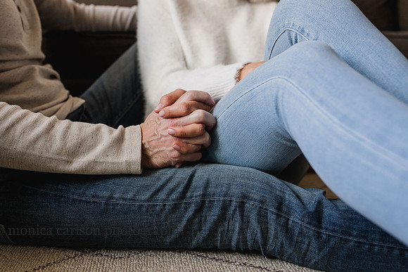 intimate portrait of a man and wife holding hands