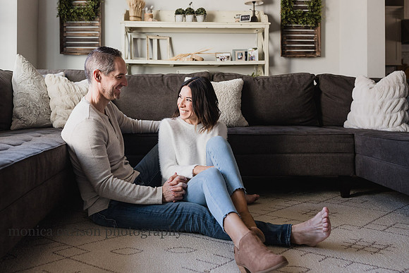 husband and wife laughing together in their home by monica carlson photography