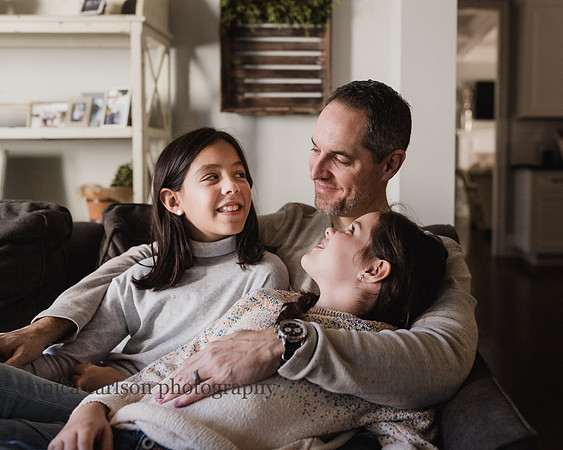 father talking to his daughters during a family photo session