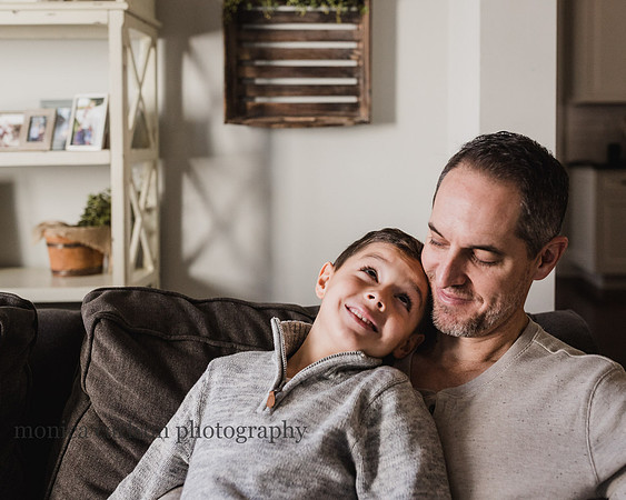 father and son chatting at home on the couch