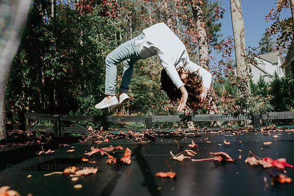 girl doing a back hand spring on a home trampoline