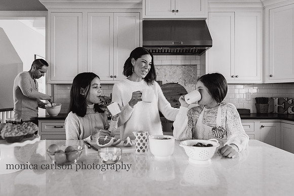 mother bonding with her daughters in the kitchen