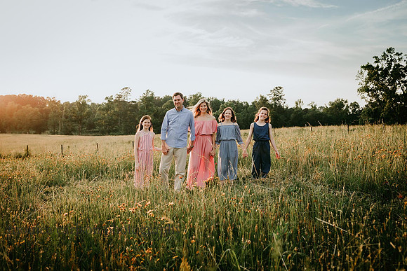 family walking on a wild flower field by monica carlson photography