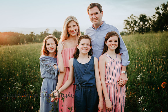 family of five on a wildflower field