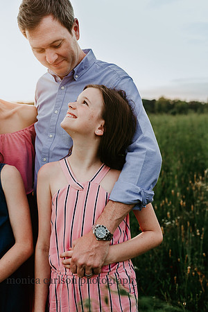 daughter looking up at her father on field in lawernceville, georgia