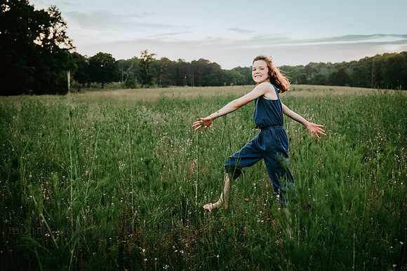 happy child skipping through a wild flower field at prospect farms