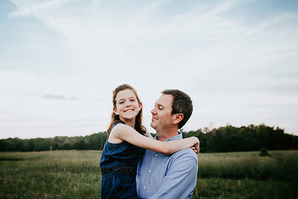 daddy carrying his happy young daughter during a session with MOnica carlson