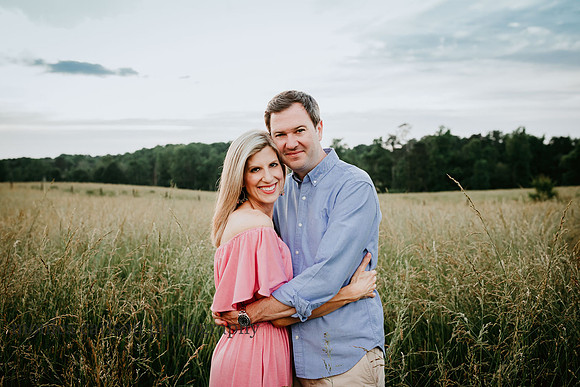 husband and wife embracing on a field at prospect farms