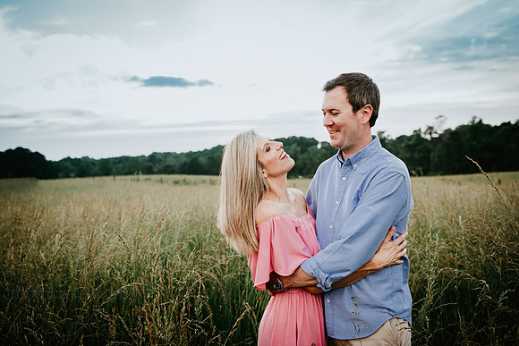 happy couple laughing together during a family session by monica carlson