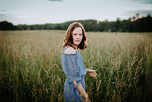 serene tween girl walking in a field by monica carlson photography