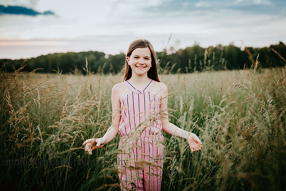 happy girl among tall grass on prospect farms