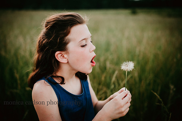 girl blowing dandelions on prospect farms