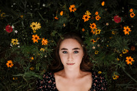 looking down at a girl surrounded by flowers